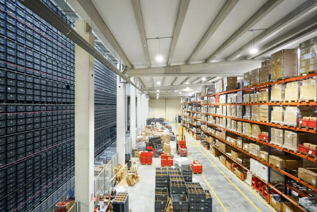 Warehouse fulfillment center with stacked inventory boxes, representing D2C channel mix and logistics in India
