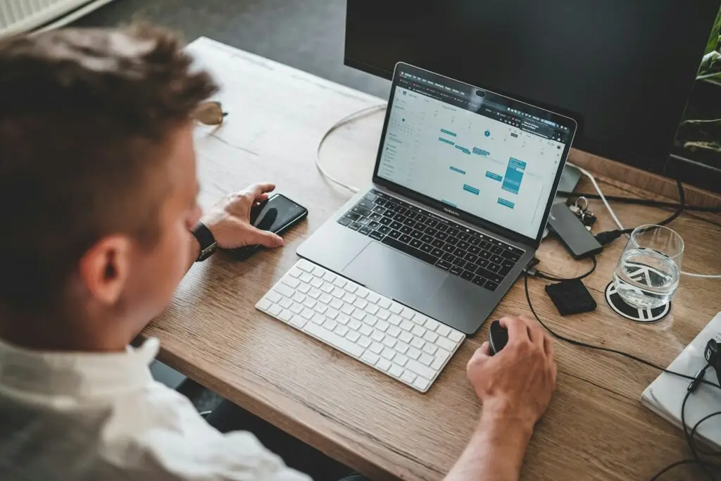 D2C startup founder working at a laptop, evaluating whether to bootstrap or raise funding for growth