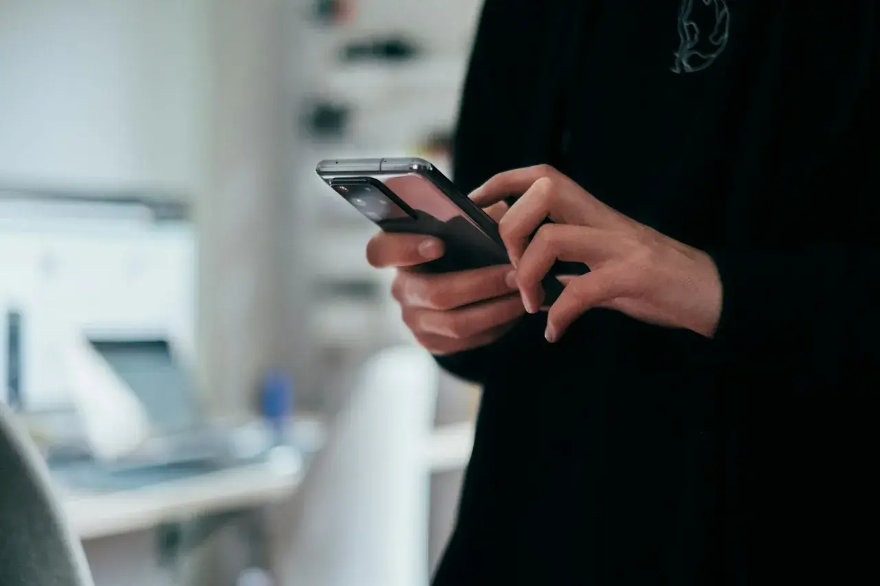 Person browsing an online shopping app on a smartphone, representing mobile-led festive sale demand