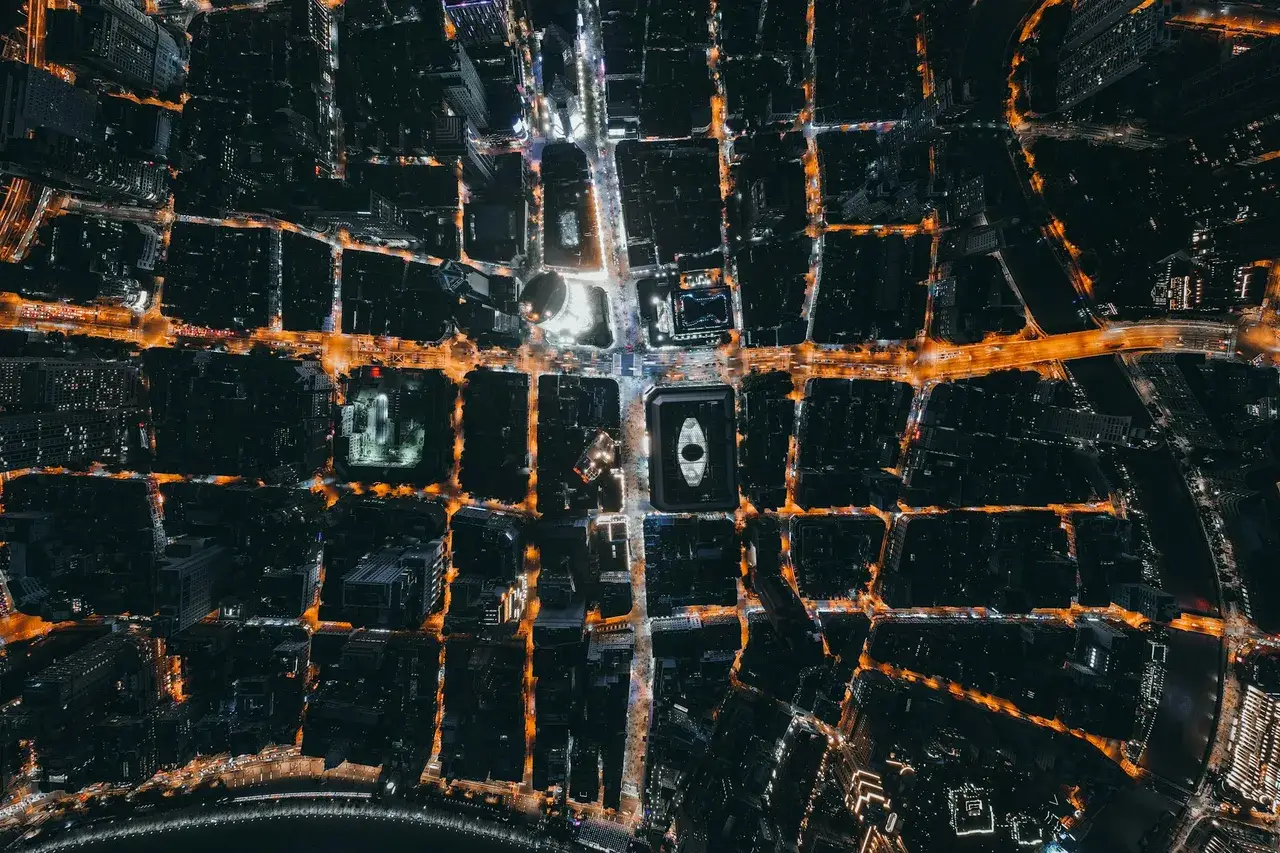 Aerial night view of a dense city grid with illuminated streets, representing pincode-level and neighbourhood-level targeting